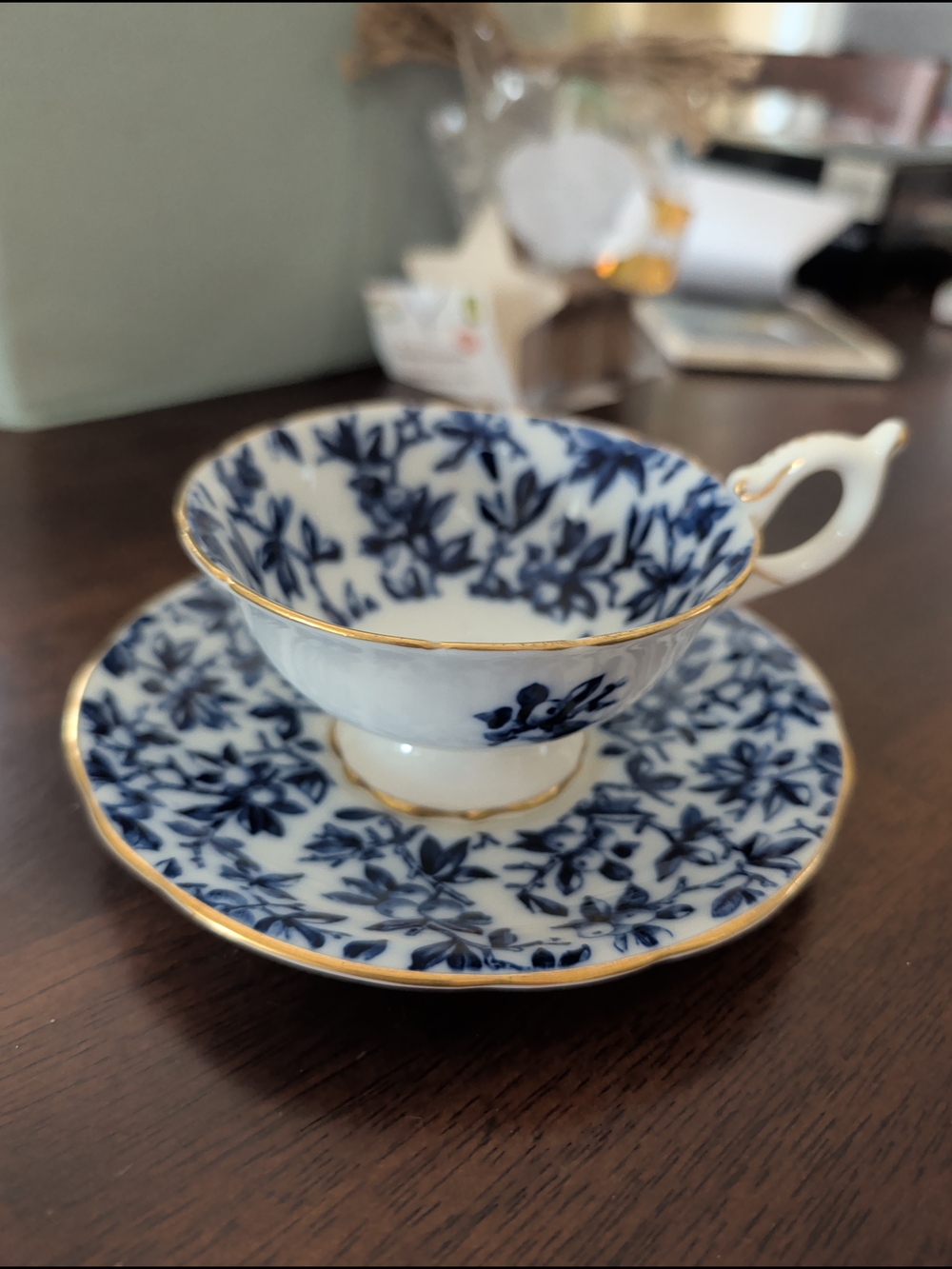 Blue Floral Porcelain Teacup and Saucer with Gold Trim